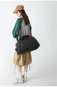 Detailed view of the independent side compartment on a black waterproof fitness bag