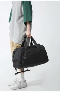 Close-up of black heavy-duty sports bag with reinforced straps and side zipper pocket