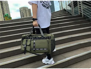 Detail of army green travel bag with tactical straps and waterproof nylon material