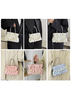 Detailed views of pleated cloud bag with pearl chain shown on models in six angles