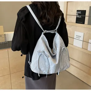 Modern light blue crinkled backpack with side zippers and ribbon detail on back