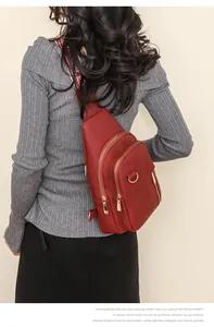 Red lychee pattern cross-body chest bag with bohemian jacquard strap on a model
