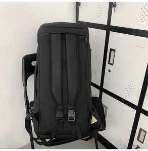 Detail of padded shoulder straps and plastic buckles on a black sports backpack