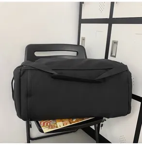 Close-up of black waterproof gym bag with sturdy handles and smooth zipper detail