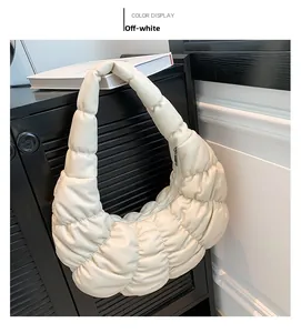 Detailed shot of an off-white ruched cloud bag showing soft texture and fine stitching