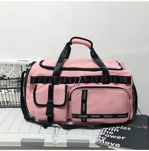 Pink travel bag detail featuring waterproof fabric with black zipper and adjustable strap