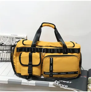 Detail of yellow waterproof nylon travel bag with YOUMAI straps and reinforced handles