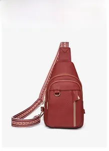 Front view of dark red crossbody chest bag with textured leather and wide woven strap