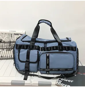 Detail view of water-resistant blue travel bag with multiple pockets and durable straps