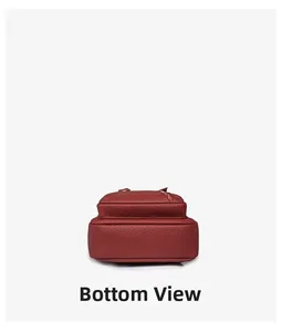 Detailed bottom view of deep red leather chest bag showing premium lychee texture