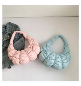 Detail of soft pleated cloud bags in pink and blue colors with puffy textured fabric