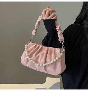 Detailansicht der rosa Falten-Cloud-Tasche mit Perlenkette und seidiger Marmortextur
