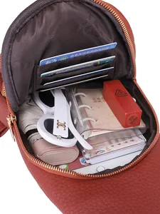 Brown leather crossbody bag with multiple slots showing interior storage capacity