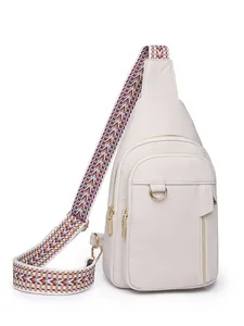 White pebbled leather crossbody chest bag with colorful woven geometric shoulder strap