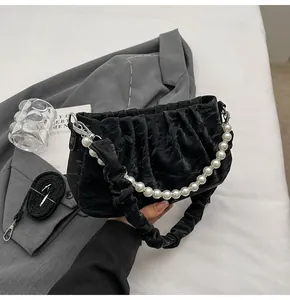 Detailansicht schwarze Cloud-Tasche mit Faltenoptik, Perlenkette und Schultergurt
