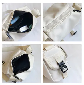 Detail view of the beige canvas messenger bag interior with adjustable strap and buckle