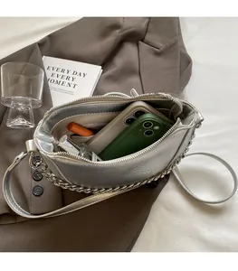 Interior view of silver chain crossbody bag showing capacity for phone and makeup