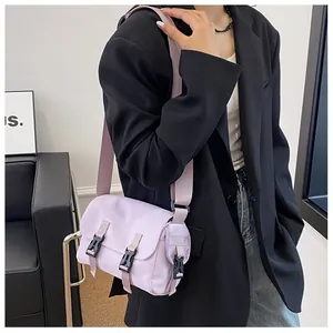 Detail view of the lavender messenger bag featuring secure black buckle closures and adjustable strap