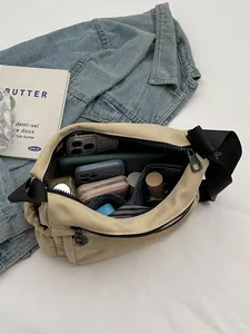 Minimalist beige nylon crossbody bag with large capacity shown in a casual flat lay set