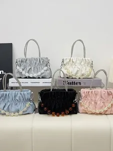 Chic pleated cloud handbag with rhinestone handle and decorative beaded chain accents