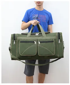 Army green large capacity travel bag held by model showing front zipper pockets