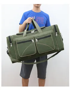 Detail view of large olive green travel bag with multiple pockets and shoulder strap