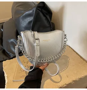 Detail of silver chain shoulder bag with metallic wrinkled faux leather and gold logo