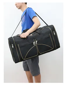 Detail of black large travel bag showing multi-pocket design and adjustable shoulder strap
