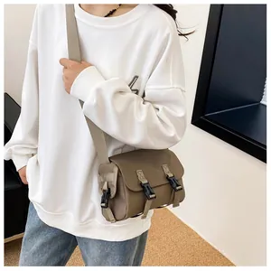 Close-up of khaki messenger bag featuring durable canvas fabric and secure buckle closures