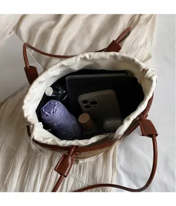 Interior view of straw bucket bag showing large capacity for tablet and accessories