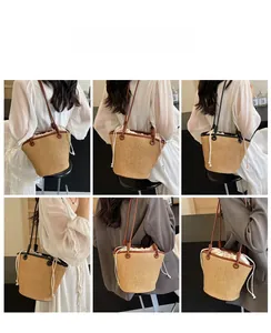 Detail view of woven straw bucket bag showing drawstring lining and leather shoulder straps