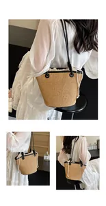 Detail of woven straw bucket bag with black leather strap and drawstring lining