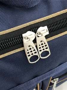 Deep blue travel bag detail showing heavy-duty double metal zippers and nylon texture