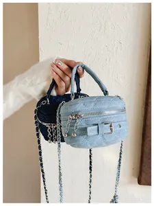 Close-up of quilted denim mini bags with silver buckles and chain zipper details