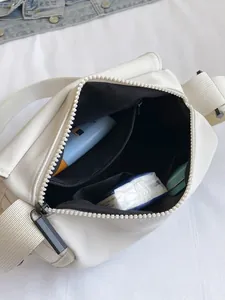 Top view of cream-white messenger bag showing spacious main interior and inner pockets