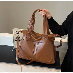 Macro view of retro caramel tote bag showing fine leather texture and metal rivet pockets