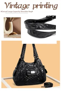 Detail of vintage black pleated leather handbag featuring quilted stitching and zippers