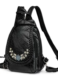 Women's black soft leather backpack with floral embroidery and rhinestone details