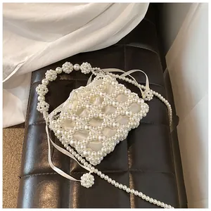 Détail du sac de soirée en perles fait main avec motif diamant et breloques sphériques