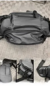 Close-up of waterproof black crossbody bag showing smooth zippers and sturdy handles