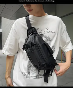 Detail view of large black waterproof nylon crossbody chest bag with multiple zip pockets