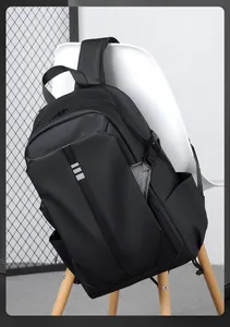 Detail of waterproof nylon black backpack with reflective stripes on a white chair