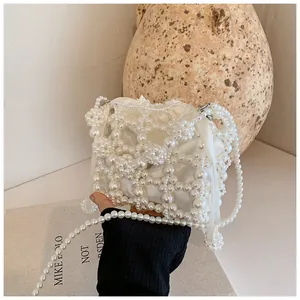 Gros plan détaillé du sac à main en perles fait main avec doublure en satin à cordon