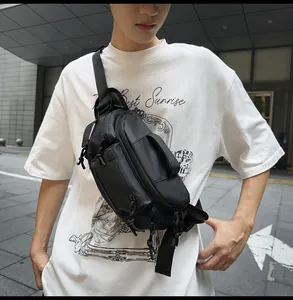 Close-up of waterproof black nylon chest bag with multiple zippers and adjustable strap