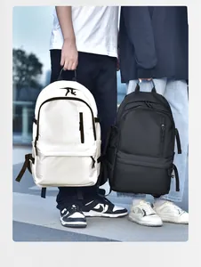 Outdoor shot of white and black high-capacity water-resistant backpacks shown by models
