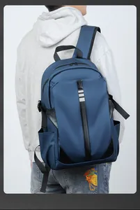 Rear view of blue waterproof backpack with safety reflective strips on a male model