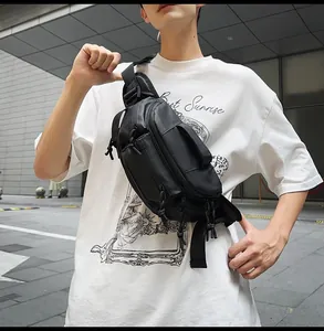 Detail showing high-capacity black crossbody bag with multi-pocket design and adjustable strap