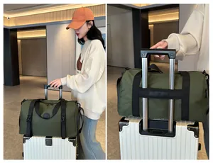 Detail of green travel bag with luggage strap sleeve attached to suitcase handle