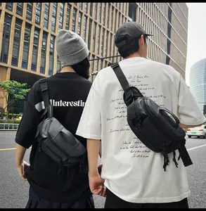 Waterproof black crossbody chest bag shown on models in a street fashion setting