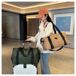 Waterproof travel bag in military green and khaki on a suitcase with a shoulder strap